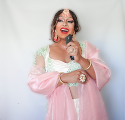 Lady Bushra in a pink outfit holding a microphone